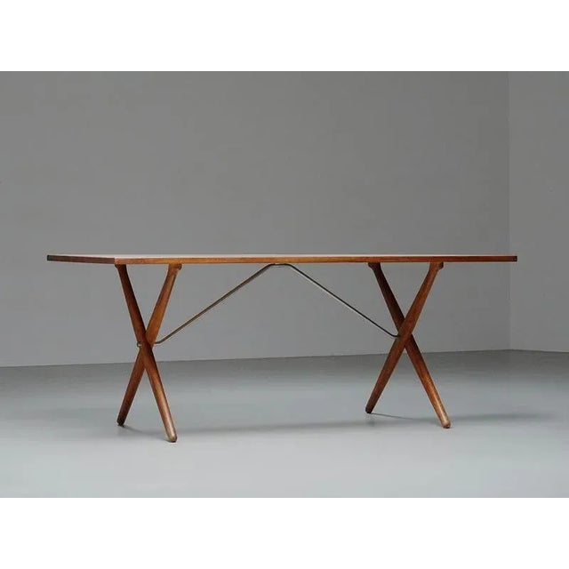 This iconic dining table, often referred to as the “sawbuck table” (model at-303), was designed by hans j. Wegner and...
