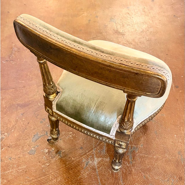 Elegant and richly detailed, this vintage vanity chair—sometimes referred to as a petite slipper or boudoir chair—combines...