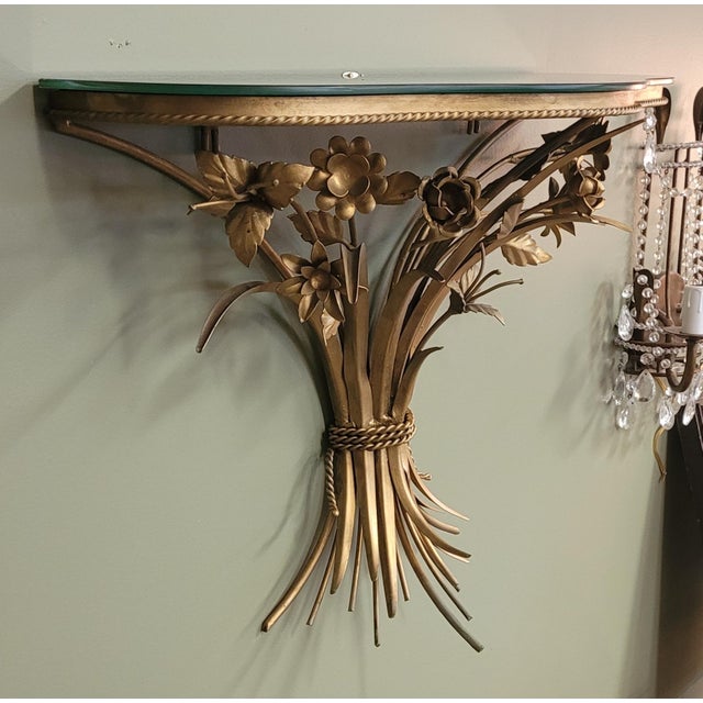 Fine vintage 1950s Gilt metal Floral wall shelf featuring guilt sprays of stems and flowers topped with a smoked elgomise...