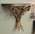 Fine vintage 1950s Gilt metal Floral wall shelf featuring guilt sprays of stems and flowers topped with a smoked elgomise...