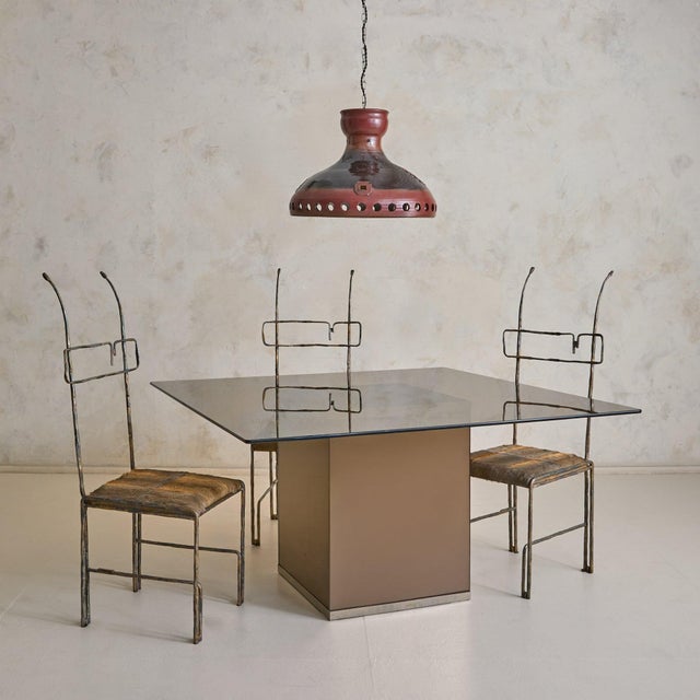 An Italian mirror and glass dining table attributed to Gavina, designed in 1975. A thick rectangular glass top, with...
