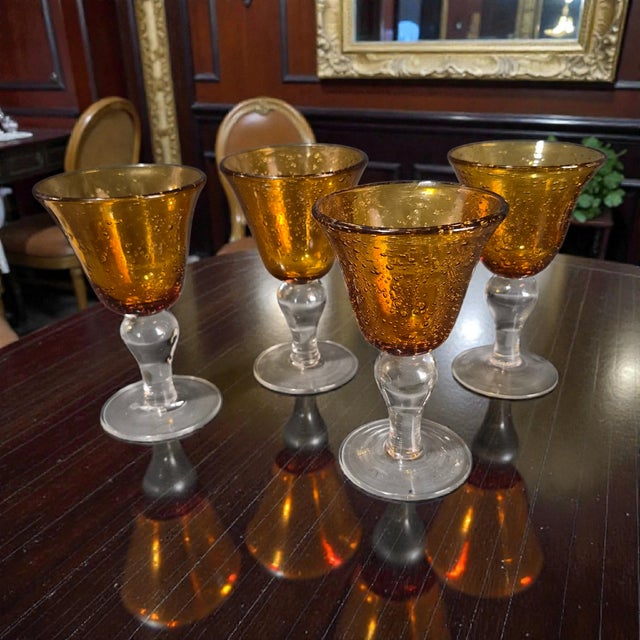 This vintage set of four amber hand-blown art glass controlled bubble goblets is a stunning example of mid-century modern...