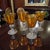 This vintage set of four amber hand-blown art glass controlled bubble goblets is a stunning example of mid-century modern...