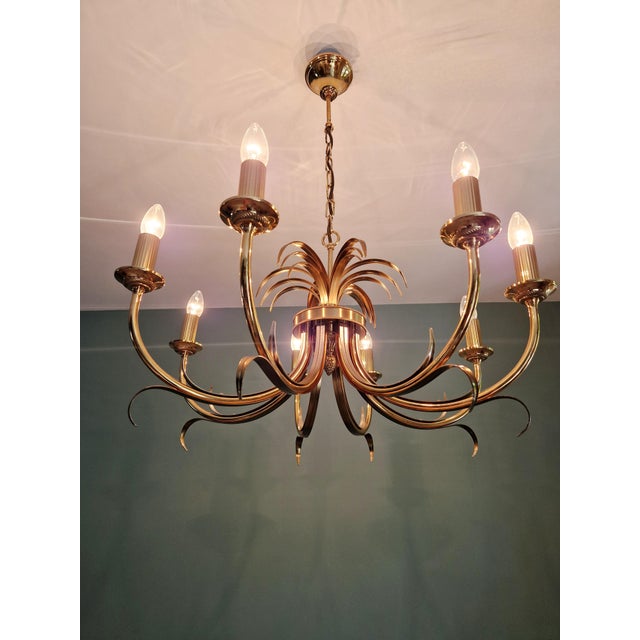 Large brass chandelier in the hollywood regency style, decorated with pineapple leaves, produced by the belgian...