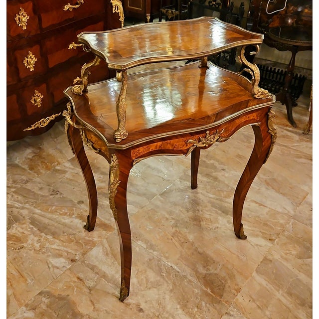 This elegant French-style serving table combines a beautifully shaped wood frame with a clear glass upper tier, creating a...