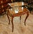 This elegant French-style serving table combines a beautifully shaped wood frame with a clear glass upper tier, creating a...