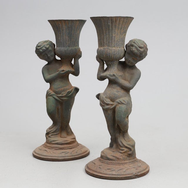 GARDEN SCULPTURES made of cast iron from the turn of the century (1900). The pieces have a rust patina and are very...