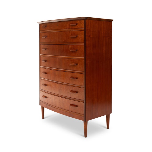 A masterful example of Danish Mid-Century Modern design, this 1960s teak tallboy dresser embodies the harmony of form,...