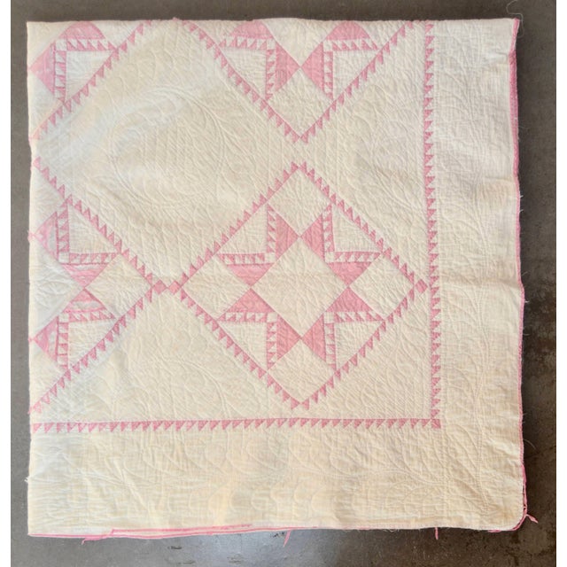 This is a charming pink-and-off-white hand-stitched quilt. It has wear throughout, which adds to its antique character and...