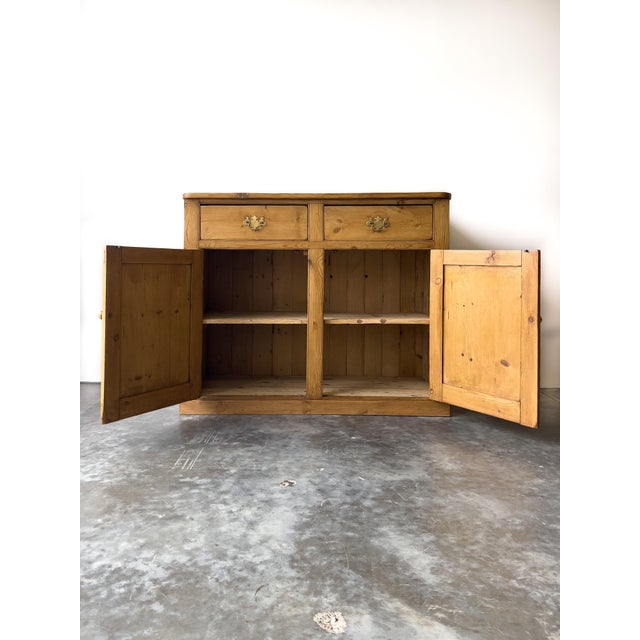 A classic piece of utility and warmth, this 19th-century English pine school cupboard boasts wonderful proportions and a...