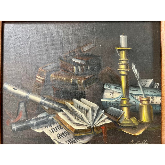 Oil on canvas original framed depicting a writers desk with a candlestick, music sheets, an antique ink and pen set and a...