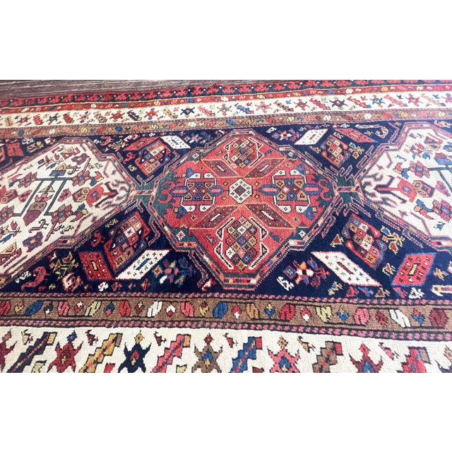 The dramatic navy blue field is organized around a series of large rust-red geometric medallions alternating with ivory...