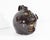 A 2000 Georgia folk art face jug by the American ceramicist Roger Corn. This ceramic piece features a stylized face, its...