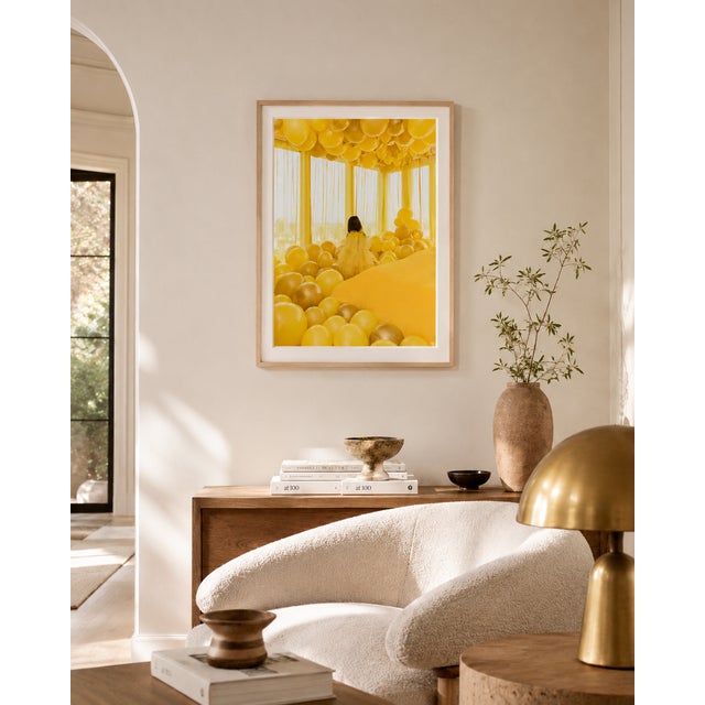A vibrant 20x30 inch, archival pigment photographic print featuring a figure surrounded by a room filled with yellow...