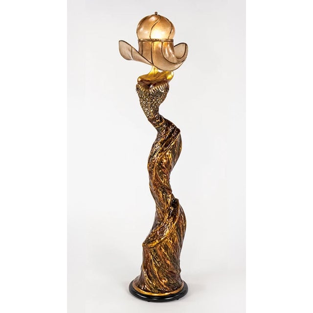 Artmax sculptural floor lamp featuring an elongated female figure with an illuminated hat-style shade. The hand-painted...