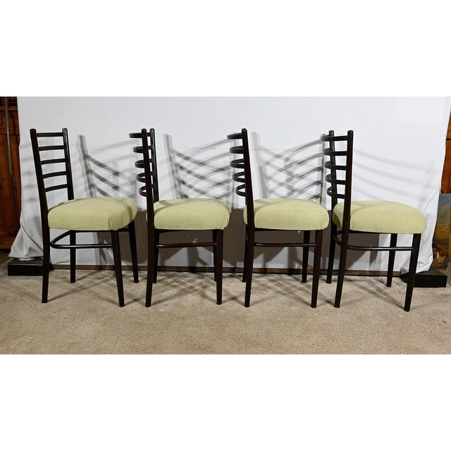 Set of vintage Scandinavian vintage wooden chairs tinted in mahogany color based on spindle feet at the front. These join...