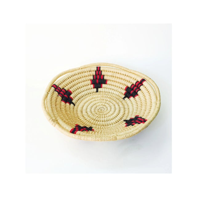 A large vintage southwestern basket made of thick coils with geometric designs in red and black. Perfect for storing odd...