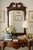 A striking Chippendale‑style mahogany wall mirror featuring a broken pediment crest, central shell motif, and pierced...