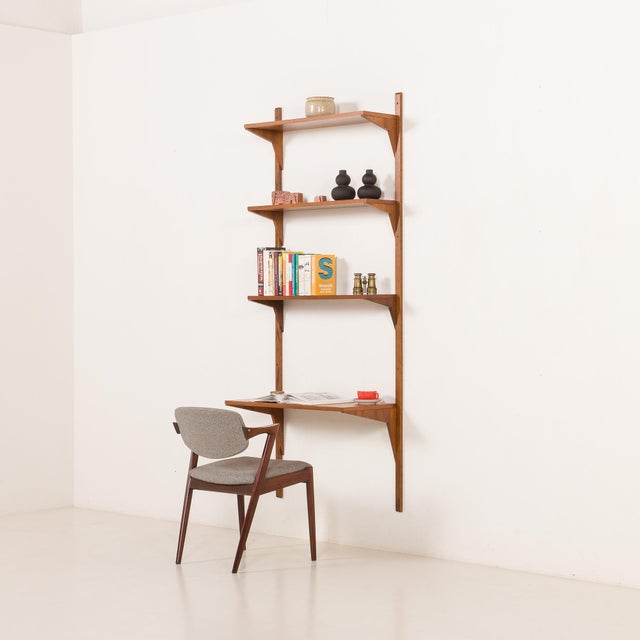 This Danish mid-century walnut shelving unit comes from the 1960s and was most likely produced by Cadovius, as indicated...