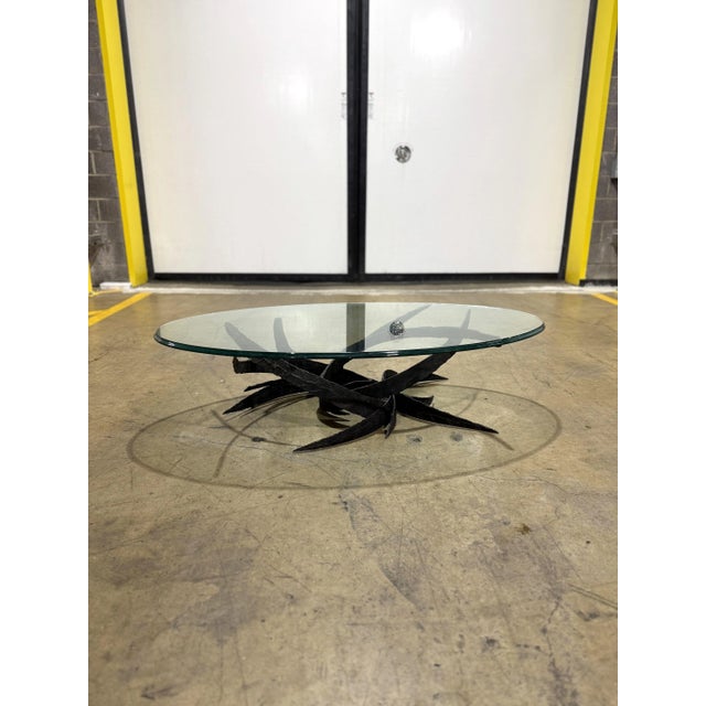 Incredible and rare cocktail table by Daniel Gluck. This amazing brutalist piece has torch cut intertwining steel pieces...