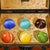 This is a striking vintage Chinese collector's set featuring a set of six cat's eye spheres housed in a finely decorated...