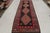 Handwoven in wool circa 1920-1930, this 4×12 antique Perisna Kilim connotes a Kermanshad rug design, exemplifying bold...