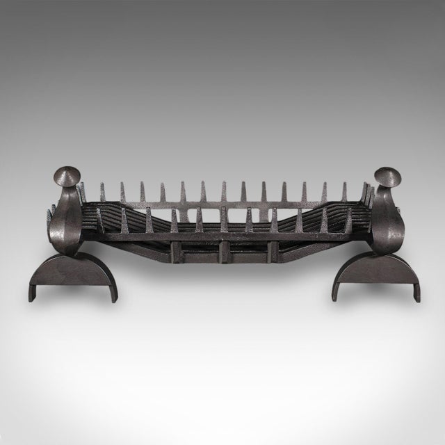 This is a large antique fireplace set. An English, cast iron fire basket and andirons suite with gothic revival taste,...