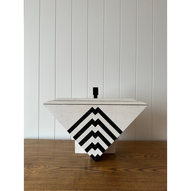 This decorative jewelry box, sculptural object, and catchall is crafted from tessellated Mactan stone with black marble...