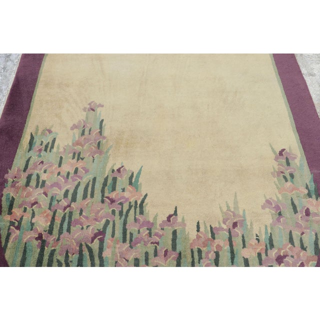 Hand-knotted in wool and originating from China circa 1920–1930, this 5x8 antique Chinese Art Deco rug is a rare...