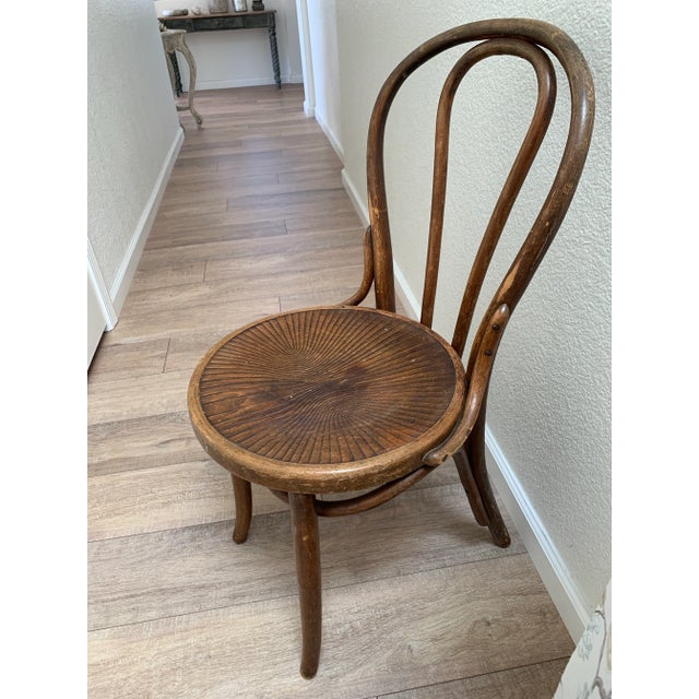 Rustic aged vintage cafe or Paris bistro chair with lots of age and natural wear. Solid wood and construction. Made in...