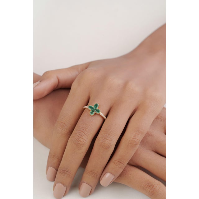 This modern four-leaf clover ring featuring 0.75 carat four pear-cut emeralds, set in 14k yellow gold. Each emerald...