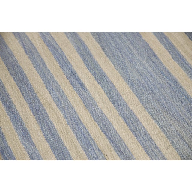 This exquisite Turkish flatweave kilim rug is a stunning masterpiece of traditional craftsmanship. Each rug is...