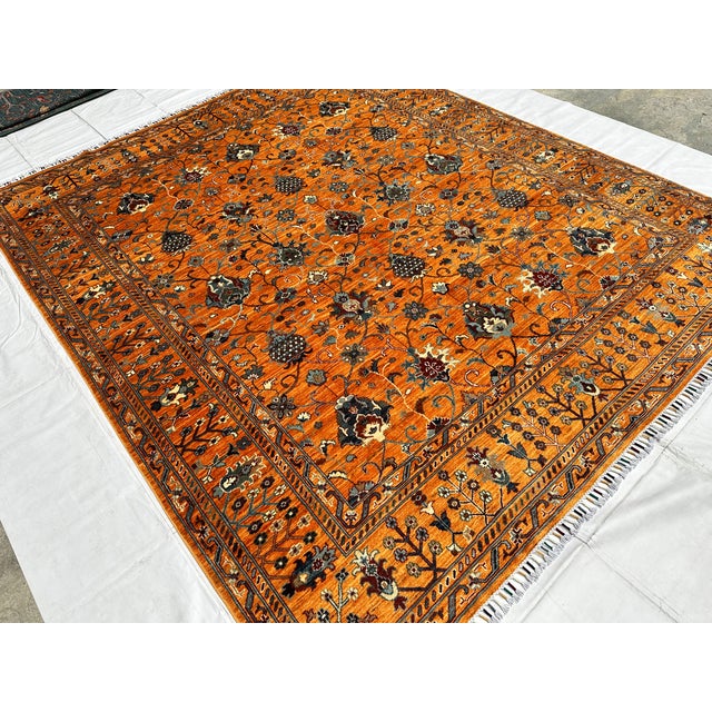 This hand-knotted Sultanabad rug features a dense allover floral lattice of palmettes, blossoms, and trailing vine scrolls...