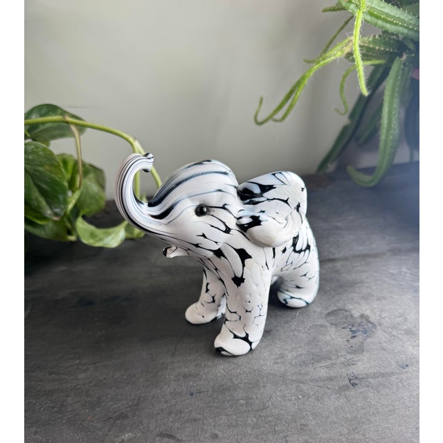 An exquisite mid-century modern Italian art glass elephant sculpture, executed in the highly sought-after "Bianco Nero"...