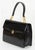Gucci Black Patent Leather Handbag, with top handle, gold-tone metal hardware, single interior zipper pocket and two slip...