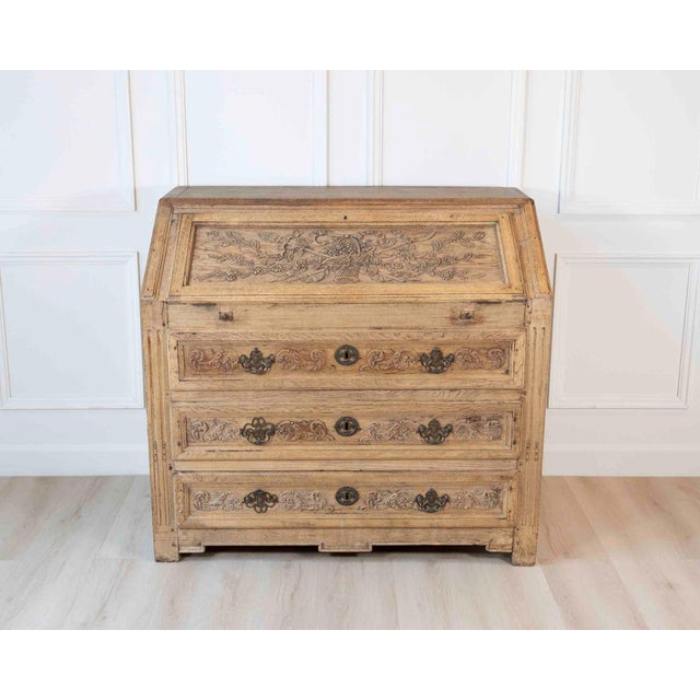 A finely carved French Louis XVI period slant-front secretary desk, crafted in natural oak in the Liège region during the...