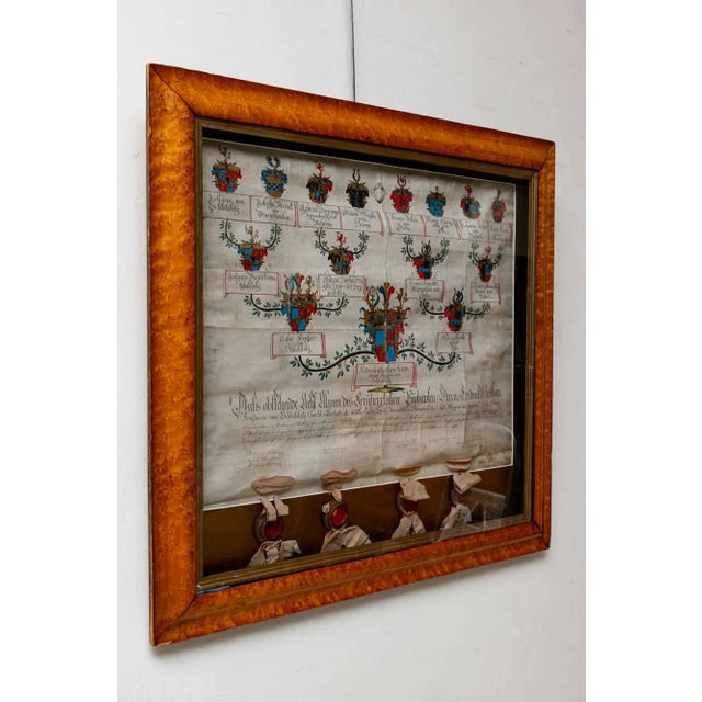 This German heraldic linage history, is on vellum paper, with original seals, glass framed in a beautiful maple wood.