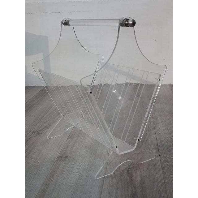 Beautiful vintage magazine rack. France, 1980s. Clear acrylic glass frame with decorative engraved lines. Chrome-plated...