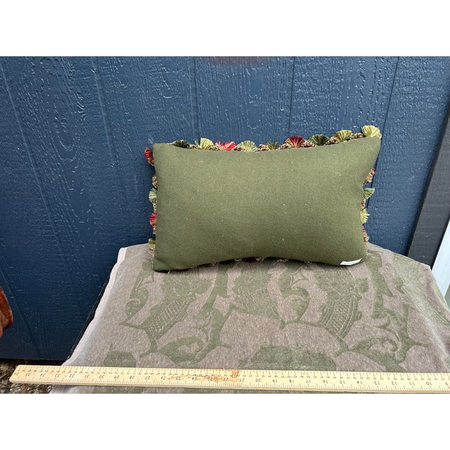A pillow made from a 19th century Scottish wool paisley shawl, embellished with coordinating tassel fringe. A down insert...