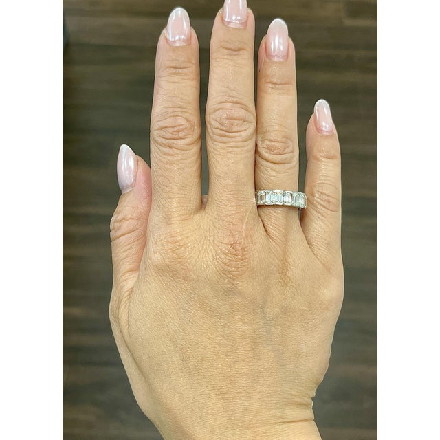 Discover this beautiful ring, featuring approximately 5.93 ct of emerald-cut diamonds with a pristine white hue. The 20...