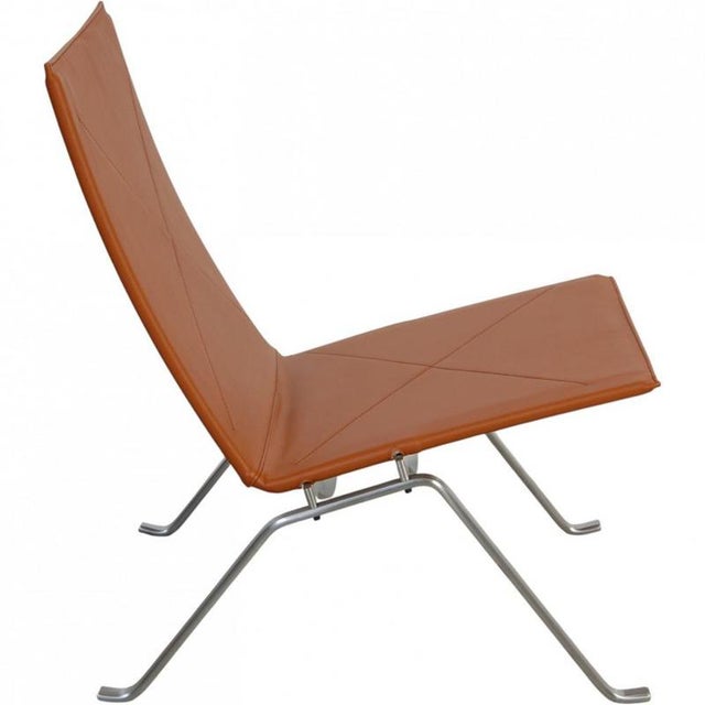 Poul Kjærholm PK22 chair upholstered with new cognac bizon leather and with a frame of brushed spring steel. The chair is...