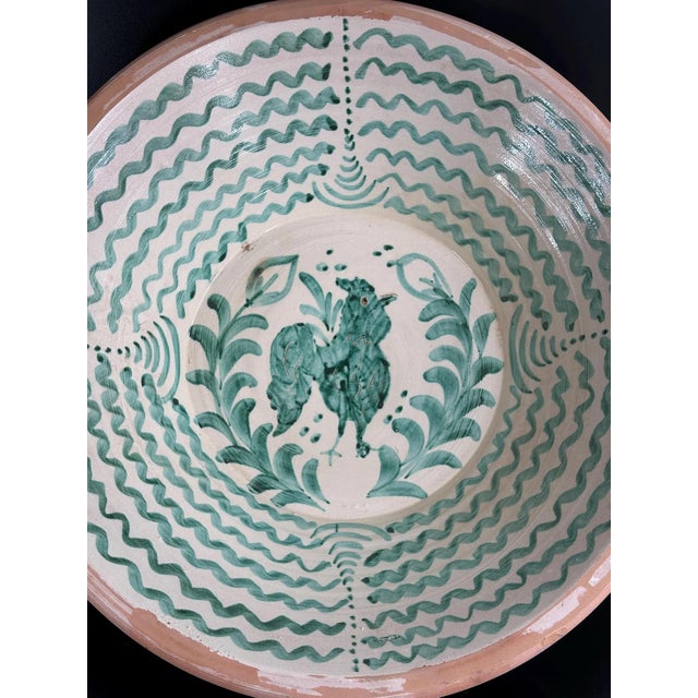 Impressive large lebrillo from the traditional Fajalauza pottery of Granada, featuring a dynamic central depiction of a...