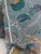 Custom pair of 22" pillows covered in a blue embroidered linen in a damask floral pattern. These pillows are welted in an...
