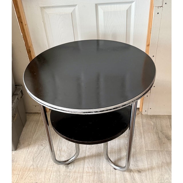 This original 1930’s streamline Art Deco occasional table was manufactured by Royalchrome. The 2 tiered design is very...