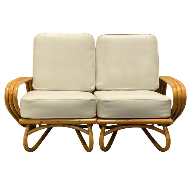 This restored 3-strand Rattan "Triple Triangle" arm sectional settee. This striking two-piece sofa features a unique loop...
