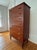 A striking Danish Modern chest of drawers in rich teak, featuring seven graduated drawers with sculpted half-moon pulls —...