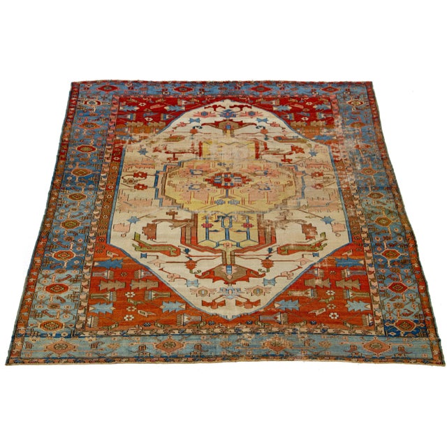 This hand-knotted wool Persian Serapi rug features a captivating medallion pattern on a beige field adorned with multiple...