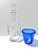 A vintage nautical barware pairing featuring a clear glass decanter etched with a detailed sailing ship and a cobalt-blue...