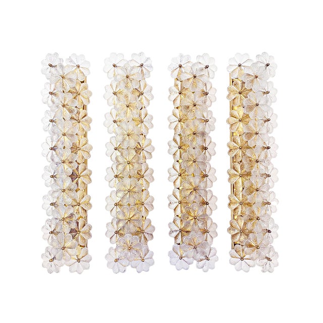 A set of 4 of extremely rare, enormous wall sconces featuring twenty-three overlapping flowers made of clear glass,...