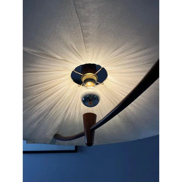 Soft light and warm materials come together in this 1970s temde pendant lamp. The cream-colored fabric shade features a...